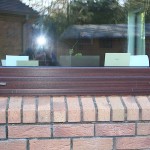 Windows finished in Mahogany wood-grain in Perfectline 70mm